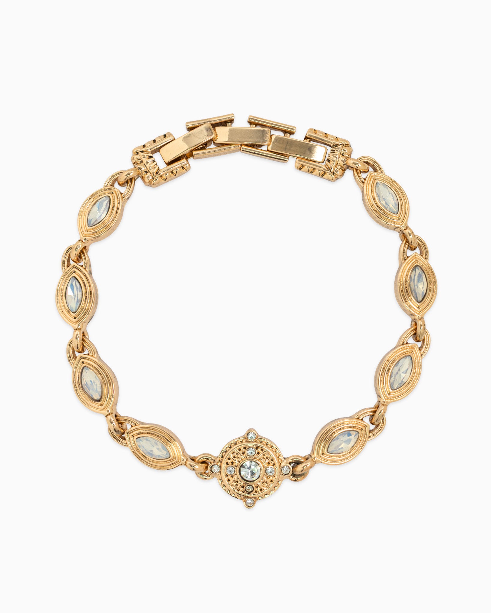 Gold bracelet with gemstone accents on a white background